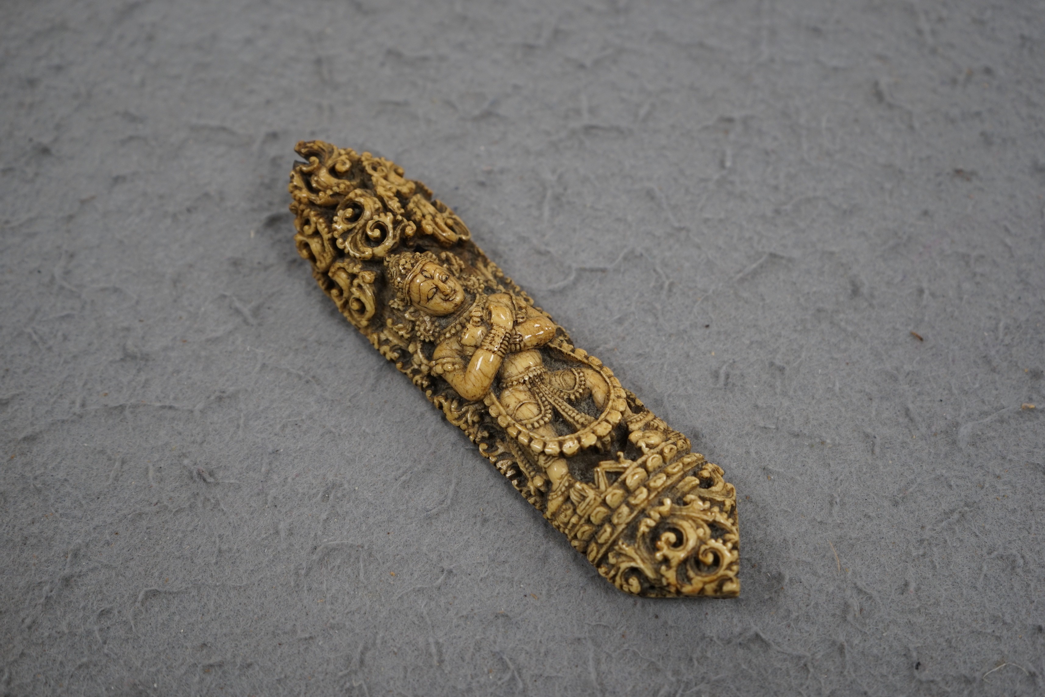 A 19th century Burmese bone carving of a Buddhist deity, 15cm tall